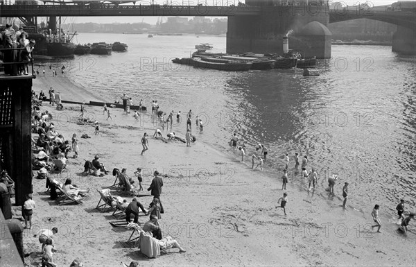 People relaxing on Tower Beach, London, c1945-c1955