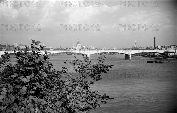 A view eastwards along the River Thames to Waterloo Bridge and the City of London, c1945-c1965 Artist