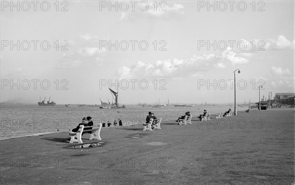 Couples sit on benches on the promenade at Gravesend, Kent, c1945-c1965