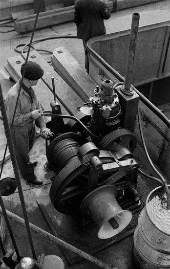 A winchman at work on the River Thames, London, c1945-c1965