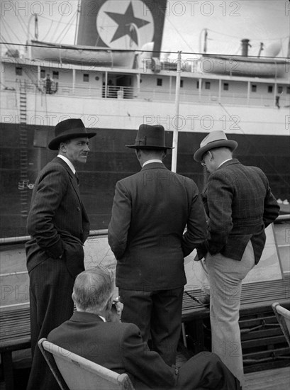Businessmen on a ship in London docks, 1937