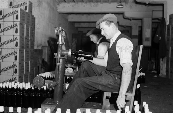 Sealing bottles of port wine at the Cutler Street warehouses, London, c1945-1965