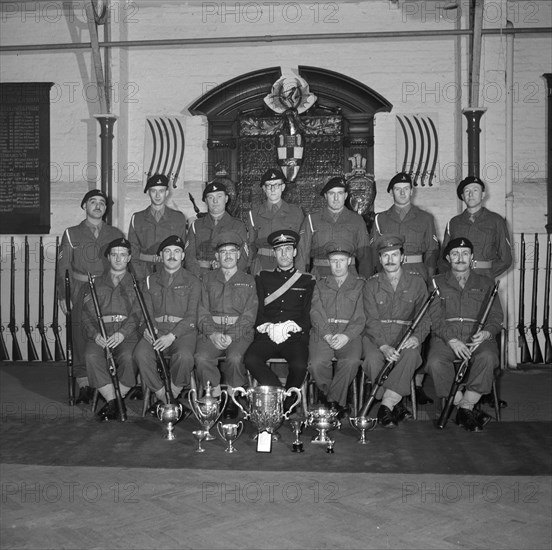 Soldiers and their officer in front of the Honourable Artillery Company's War Memorial, c1945-c1965