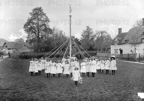Children dance around the village maypole, East Hanney, Oxfordshire, c1860-c1922