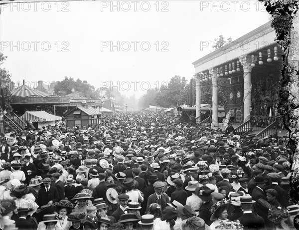 Crowded street showing a stage and carousel at St Giles Fair, Oxford, Oxfordshire, c1860-c1922