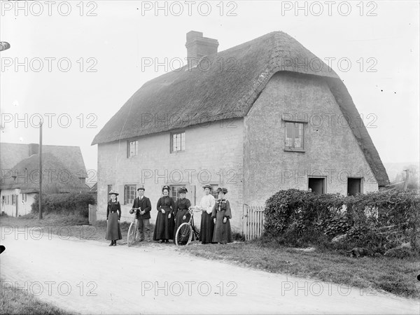 People standing outside a thatched cottage, Uffington, Oxfordshire, 1916