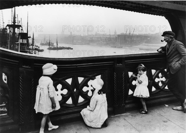 People watching the Thames from Tower Bridge, City of London, c1930. Artist: George Davison Reid