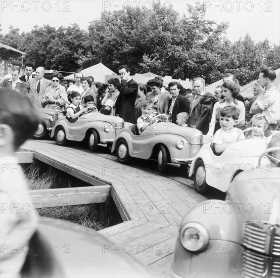 Children on a fairground ride, Festival of Britain, 1951. Artist: Henry Grant