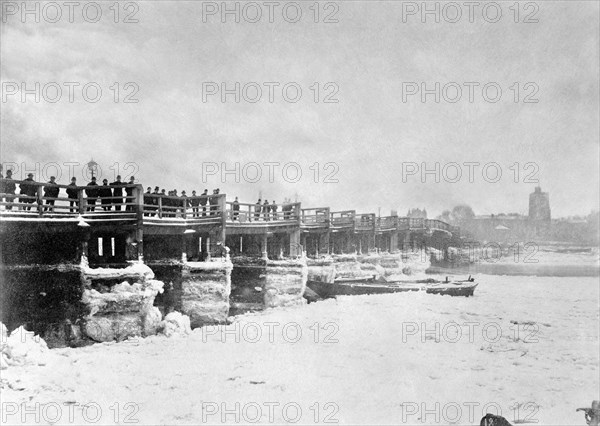 People looking at the frozen Thames from Old Putney Bridge looking South, Putney, London, c1881. Artist: Unknown