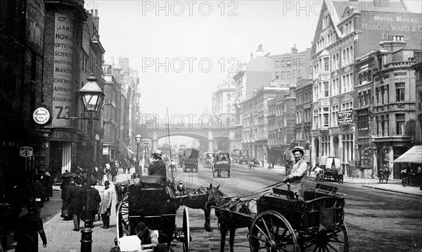 People walking down Farringdon Street looking towards Holborn Viaduct, City of London, 1890. Artist: Unknown