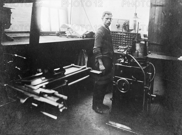 Man in a printing workshop, (late 19th-early 20th century?). Artist: W Martin