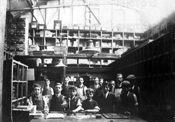 Men and boys in a printing workshop, (late 19th-early 20th century?). Artist: Unknown