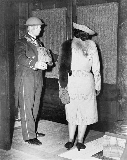 Linkman at the Trocadero wearing a tin hat, Westminster, London, October 1940. Artist: Unknown