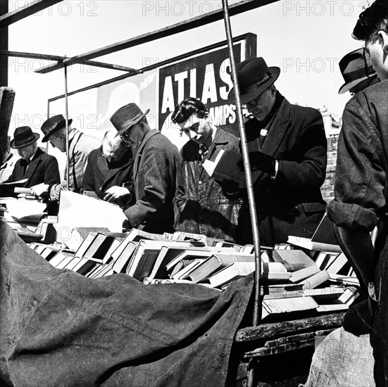 Shoppers at a London bookstall, c1950s. Artist: Henry Grant