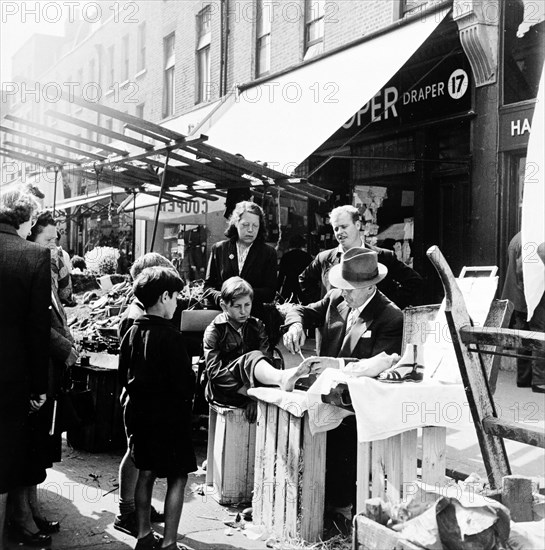 Corn Cure, Chapel Street Market, Islington, London, 1955. Artist: Henry Grant