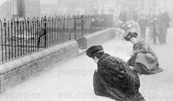 Emma Sproson (left) and a friend chalking the pavement, 1907. Artist: Unknown