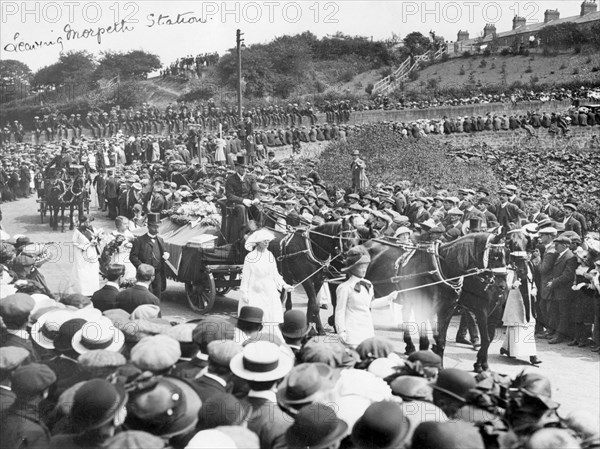 A large crowd watches Emily Wilding Davison's funeral procession 15th June 1913. Artist: Unknown