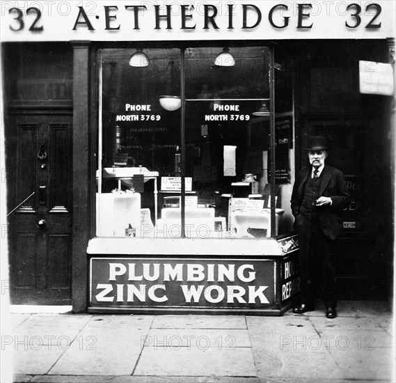 A Etheridge plumber's shop, possibly in Holloway Road, Islington, London, early 20th century. Artist: Henry Grant