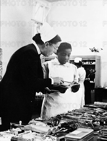 A nurse being trained, 1960. Creator: Henry Grant.