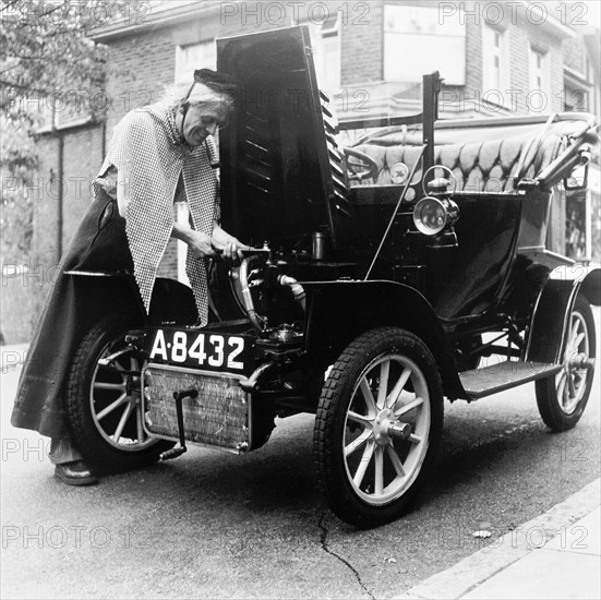 Man in fancy dress with a veteran car, London, (c1960-c1980?). Artist: Henry Grant