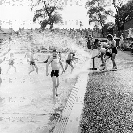 Children playing in a London paddling pool, c1950s. Artist: Henry Grant