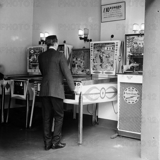 Man playing pinball in a London amusement arcade, c1966-67. Artist: Henry Grant