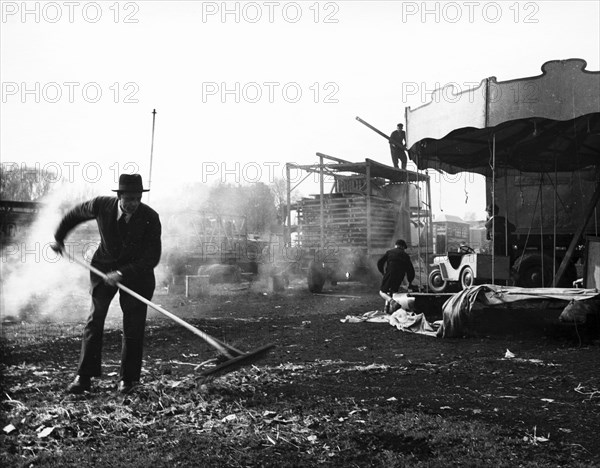 Cleaning up at Hampstead Funfair, April 1952. Artist: Henry Grant