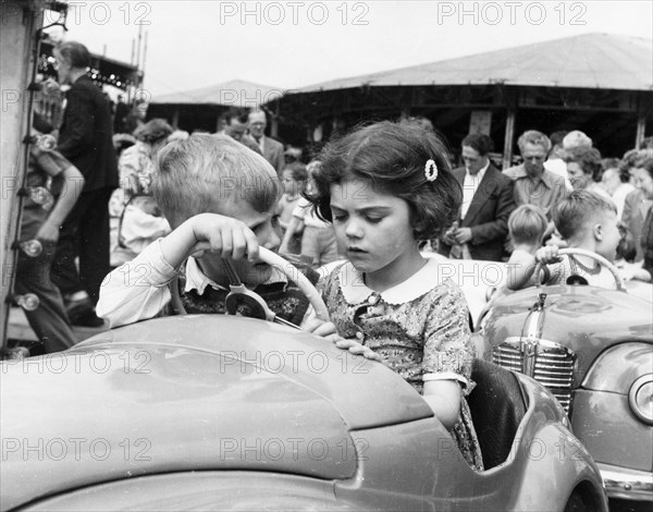 Children on a ride at Hampstead funfair, London, c1950. Artist: Henry Grant