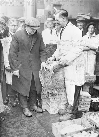 Man choosing fish at Billingsgate Market, London, (c1930s?). Artist: Unknown