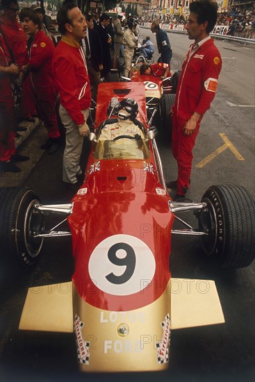 Colin Chapman and a mechanic in discussion over Graham Hill's Lotus, Monaco Grand Prix, 1969. Artist: Unknown