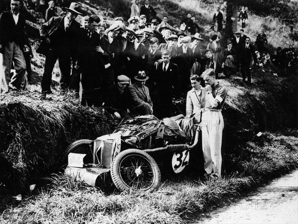 Goldie Gardner by the wreckage of an MG J4, 1932. Artist: Unknown