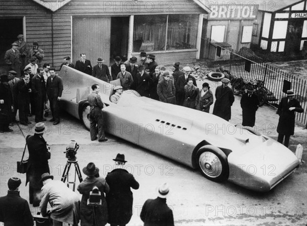 Malcolm Campbell being photographed in Bluebird, 1935