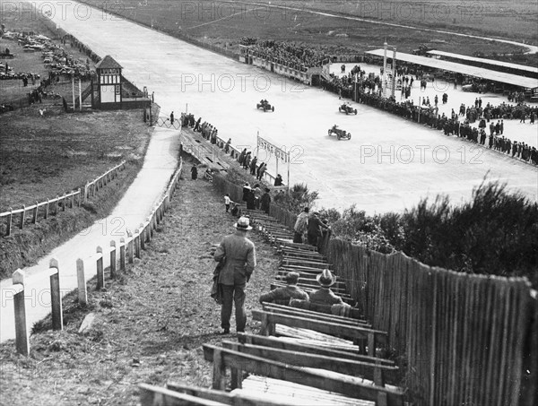 Spectators watching motor racing from the Test Hill, Brooklands, Surrey, (1920s?). Artist: Unknown