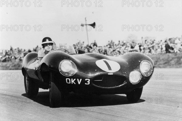 Mike Hawthorn driving a D Type Jaguar, c1955-c1956. Artist: Unknown