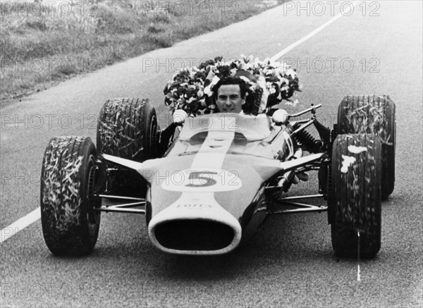 Jim Clark in a Lotus with the winner's laurel wreath. Artist: Unknown