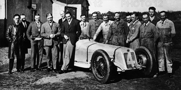 Robert Benoist with a cigarette, leaning against a Delage 15-S8, 1927. Artist: Unknown