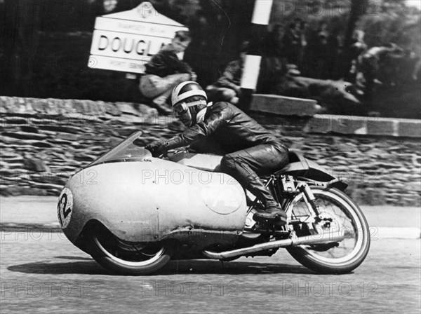 Bill Lomas at Governor's Bridge, Isle of Man Junior TT, 1955. Artist: Unknown