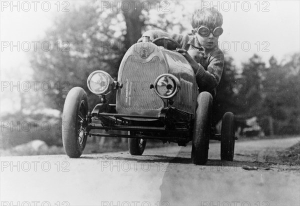 Boy in a pedal car. Artist: Unknown