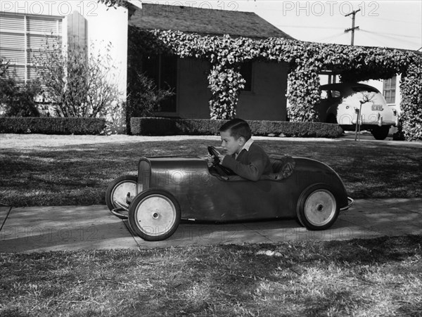 Boy in a pedal car. Artist: Unknown