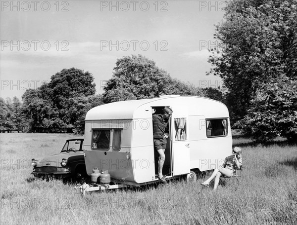 Couple on holiday with their 1963 Sprite Alpine caravan, (c1963?). Artist: Unknown