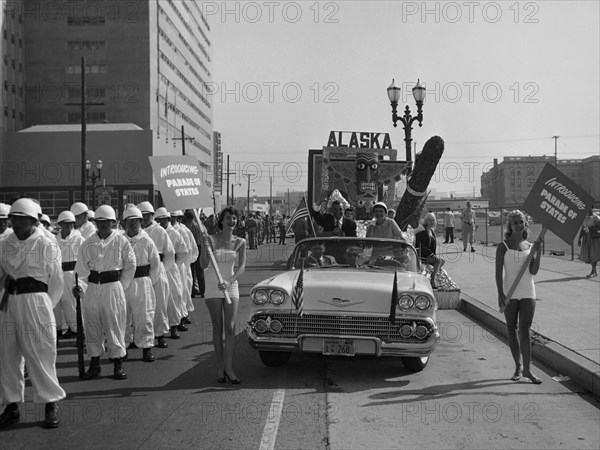 Models and a Cadillac on a parade, USA, (c1959?). Artist: Unknown