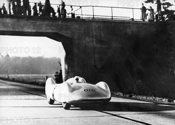 Bernd Rosemeyer driving an Auto Union, c1937-c1938. Artist: Unknown