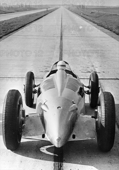 Bernd Rosemeyer in Auto Union record-breaking car, 1937. Artist: Unknown