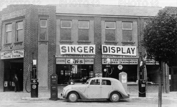 A Singer 11hp Airstream saloon car outside a Welsh garage, Wales, 1935. Artist: Unknown