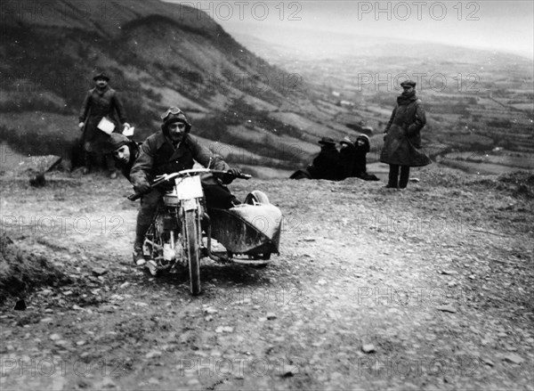 Jack Thomas riding a Norton, competing in the South Wales Trial, 1921. Artist: Unknown