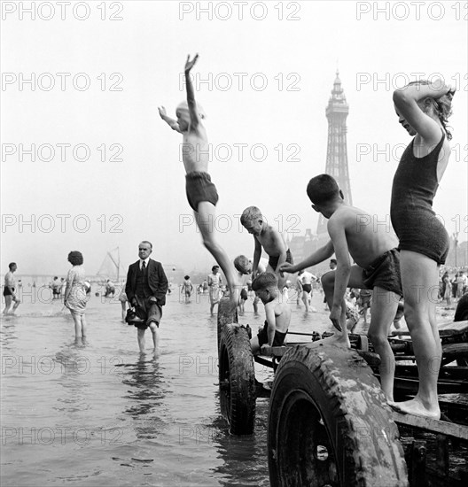 Children in swimming costumes jump into the sea, Blackpool, c1946-c1955