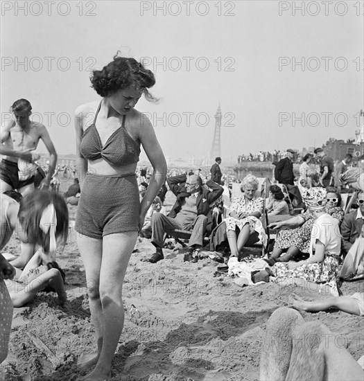 A young woman in a knitted bathing costume on the beach, Blackpool, c1946-1955