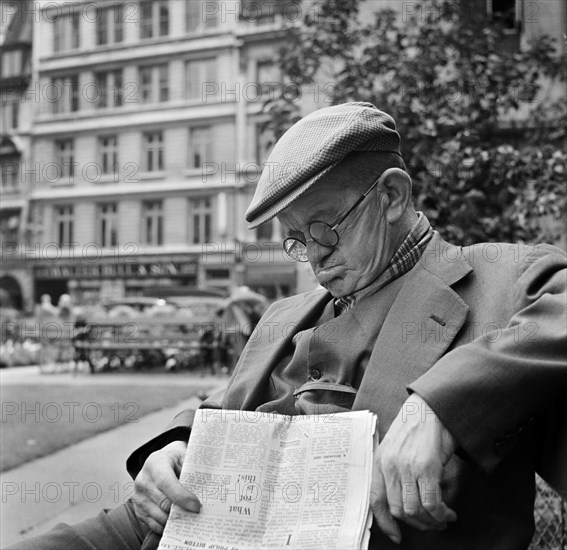 An elderly man asleep with his newspaper, City of London, c1946-c1959