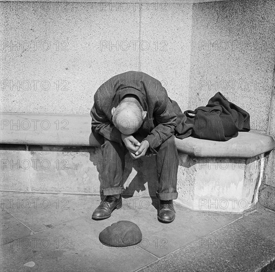 Man seated on a stone bench on Blackfriars Bridge, London, c1946-c1959