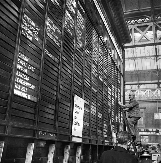 Repairing the departure board at Victoria Station, London, 1960-1972